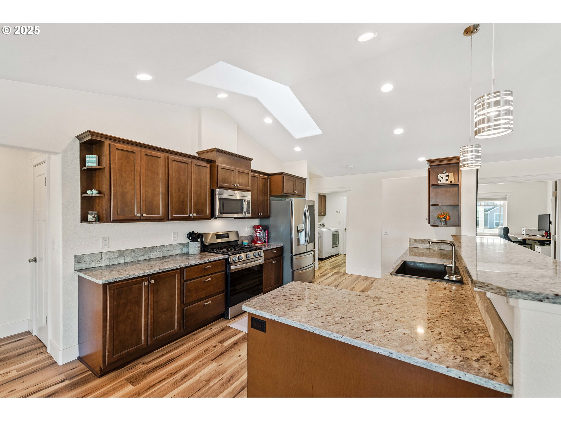 2669 Cedar Loop Bandon, OR 97411 - Photo 11 of 48 a kitchen with granite countertop stainless steel appliances and wooden cabinets