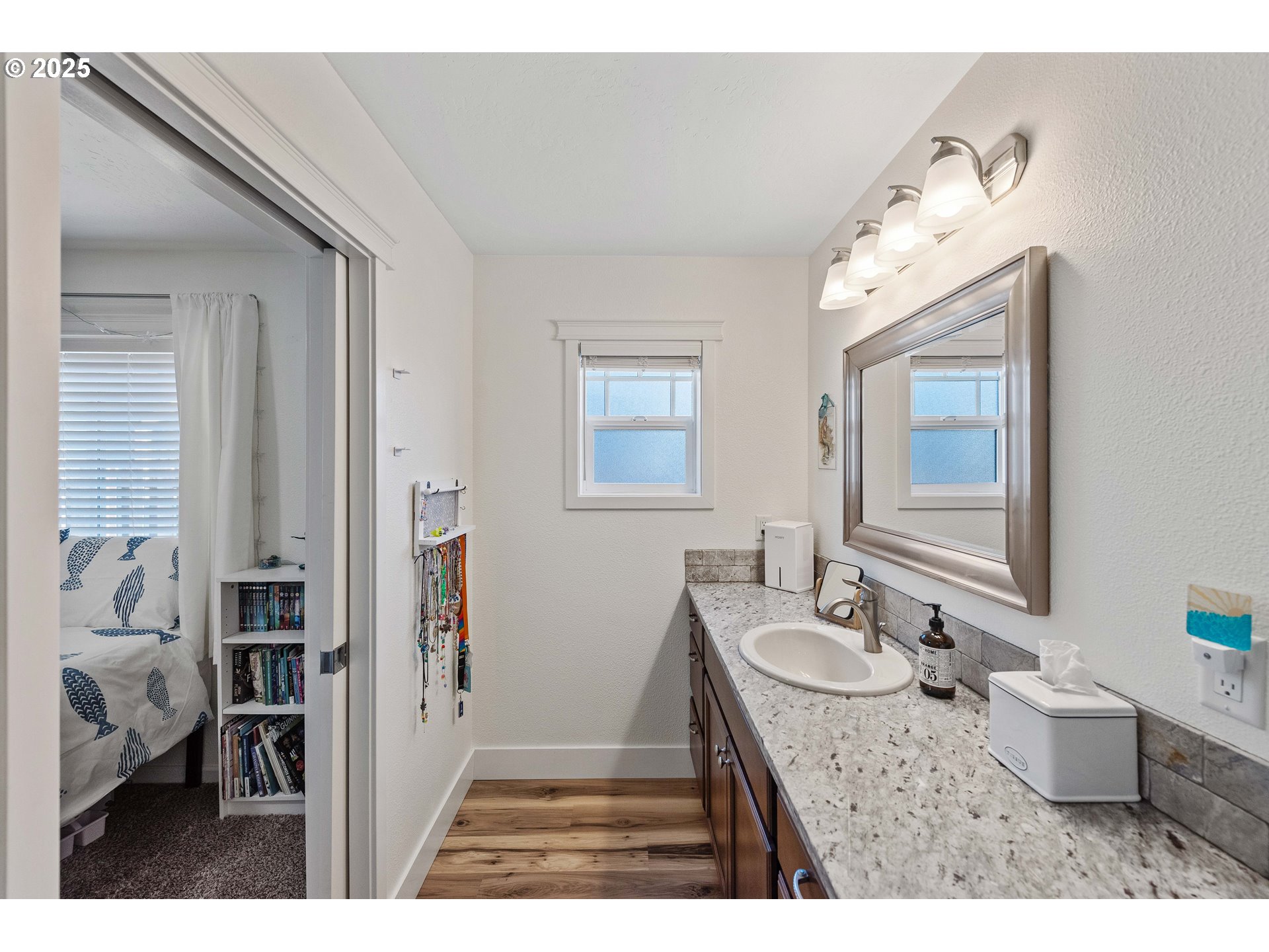 2669 Cedar Loop Bandon, OR 97411 - Photo 24 of 48 a bathroom with a granite countertop sink mirror and a bathtub