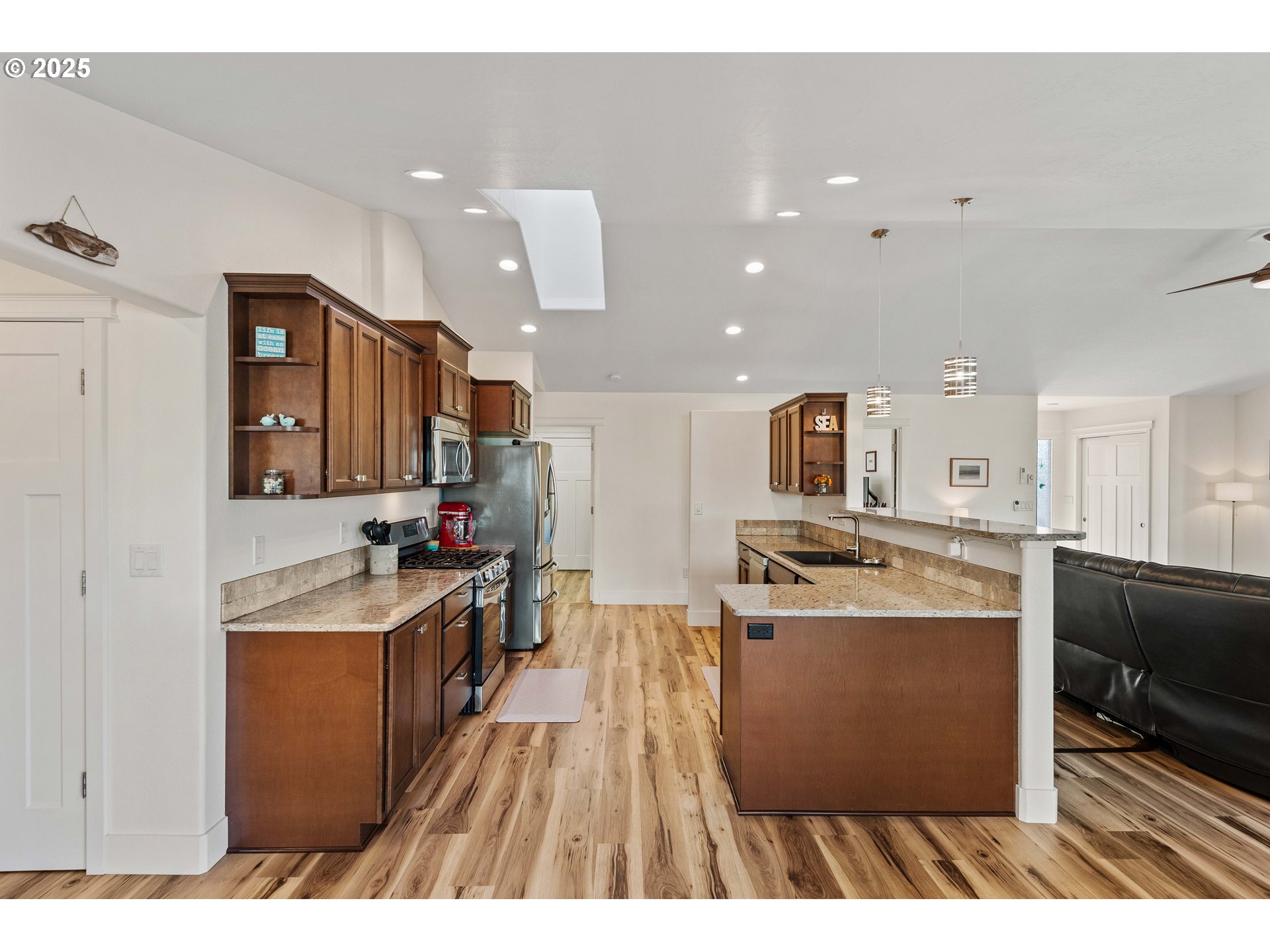 2669 Cedar Loop Bandon, OR 97411 - Photo 10 of 48 a kitchen with stainless steel appliances granite countertop a stove oven and a refrigerator