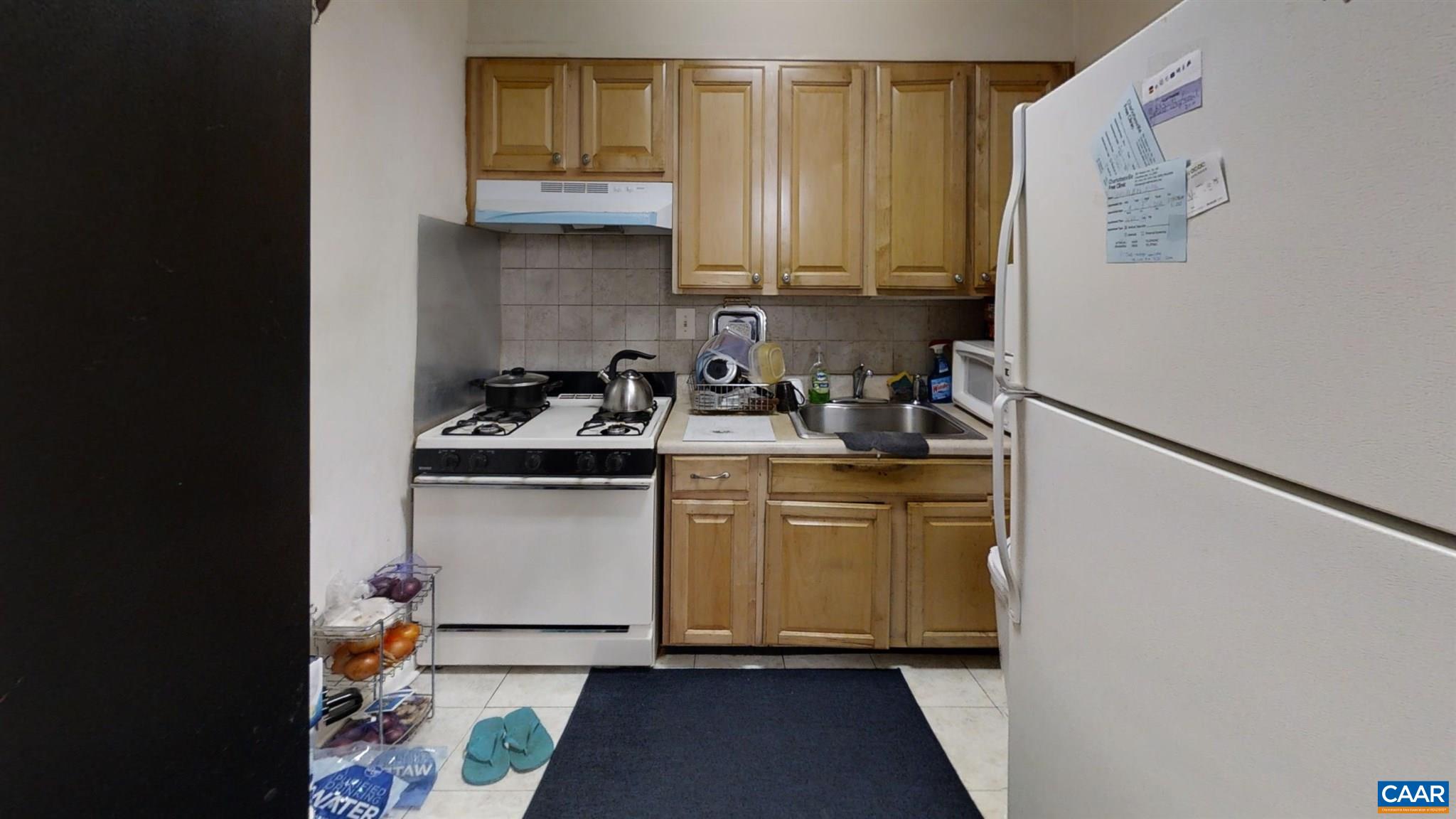 2527 Hydraulic Road, Unit 55 Charlottesville, VA 22901 - Photo 12 of 17 a kitchen with a sink and a refrigerator
