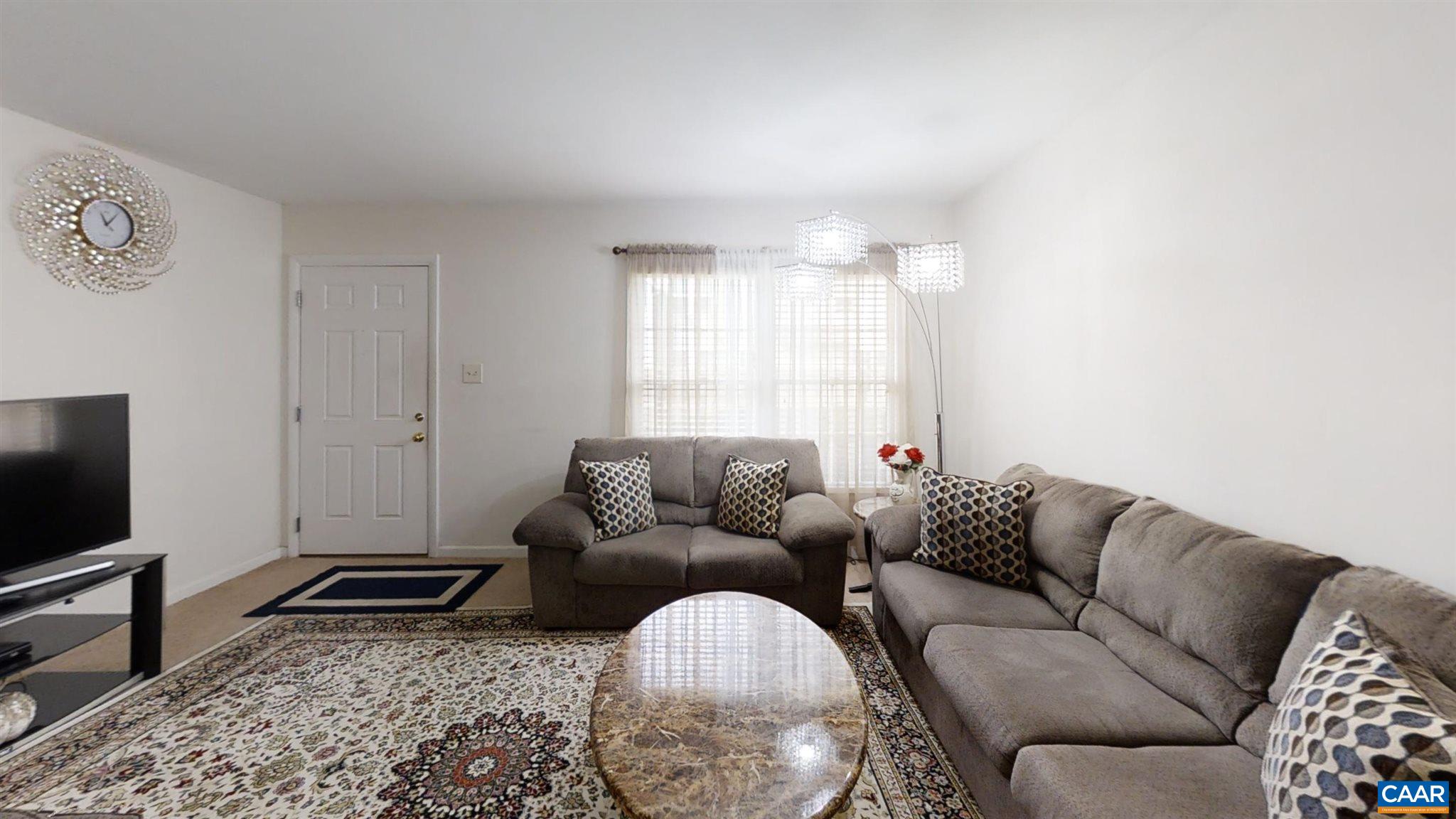 2527 Hydraulic Road, Unit 55 Charlottesville, VA 22901 - Photo 13 of 17 a living room with furniture and a flat screen tv