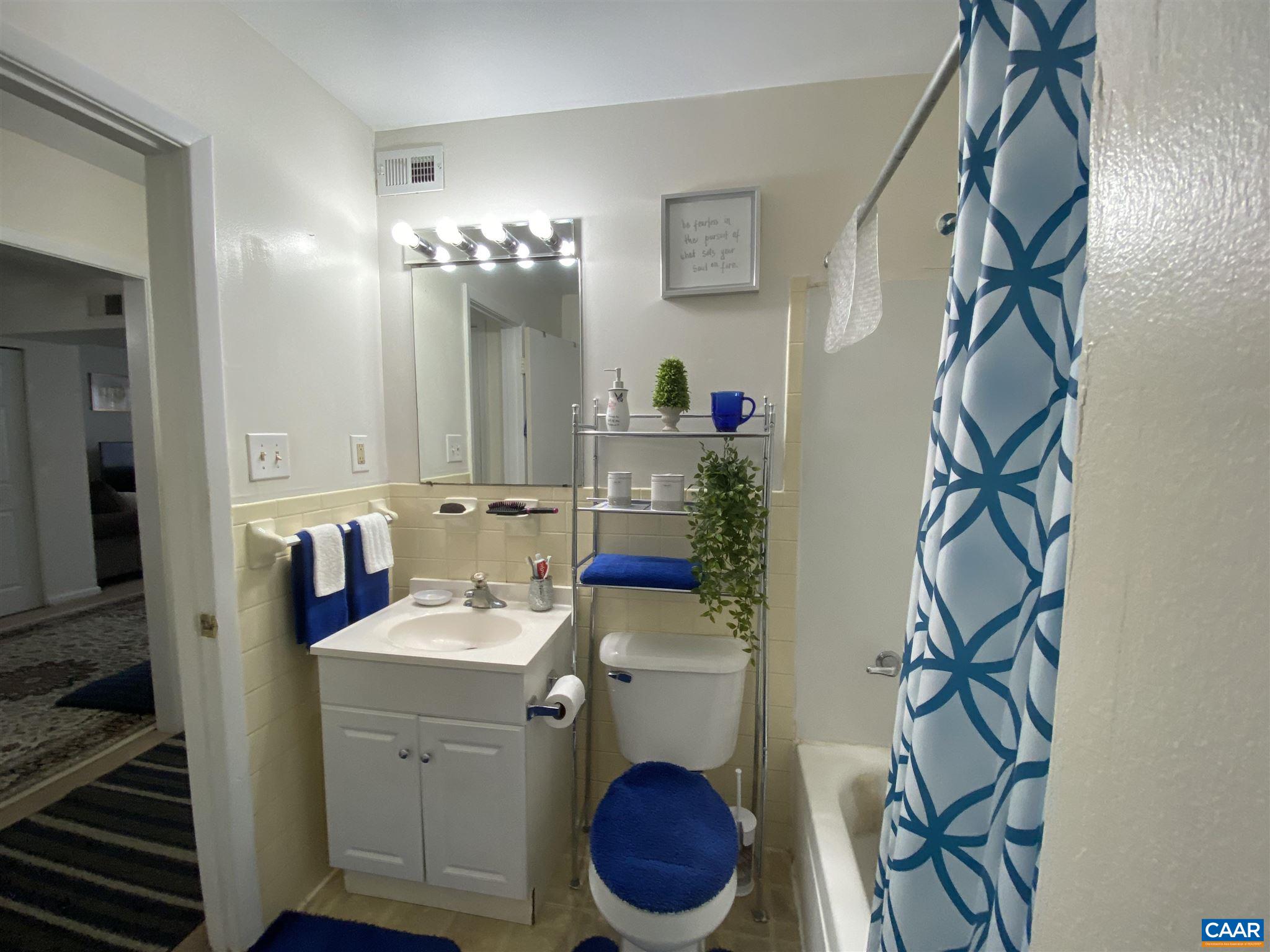 2527 Hydraulic Road, Unit 55 Charlottesville, VA 22901 - Photo 15 of 17 a bathroom with a sink toilet and a mirror