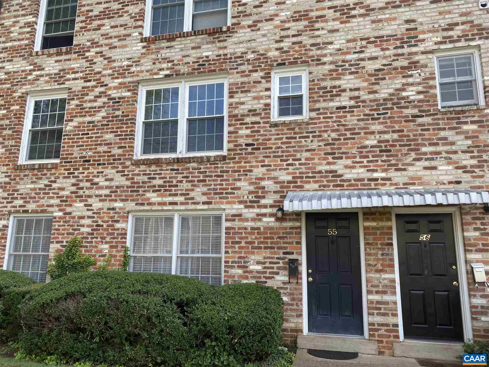 2527 Hydraulic Road, Unit 55 Charlottesville, VA 22901 - Photo 16 of 17 a view of a brick house with many windows