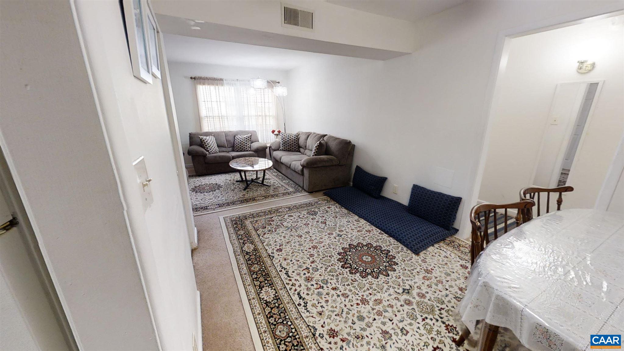 2527 Hydraulic Road, Unit 55 Charlottesville, VA 22901 - Photo 5 of 17 a living room with furniture and a rug