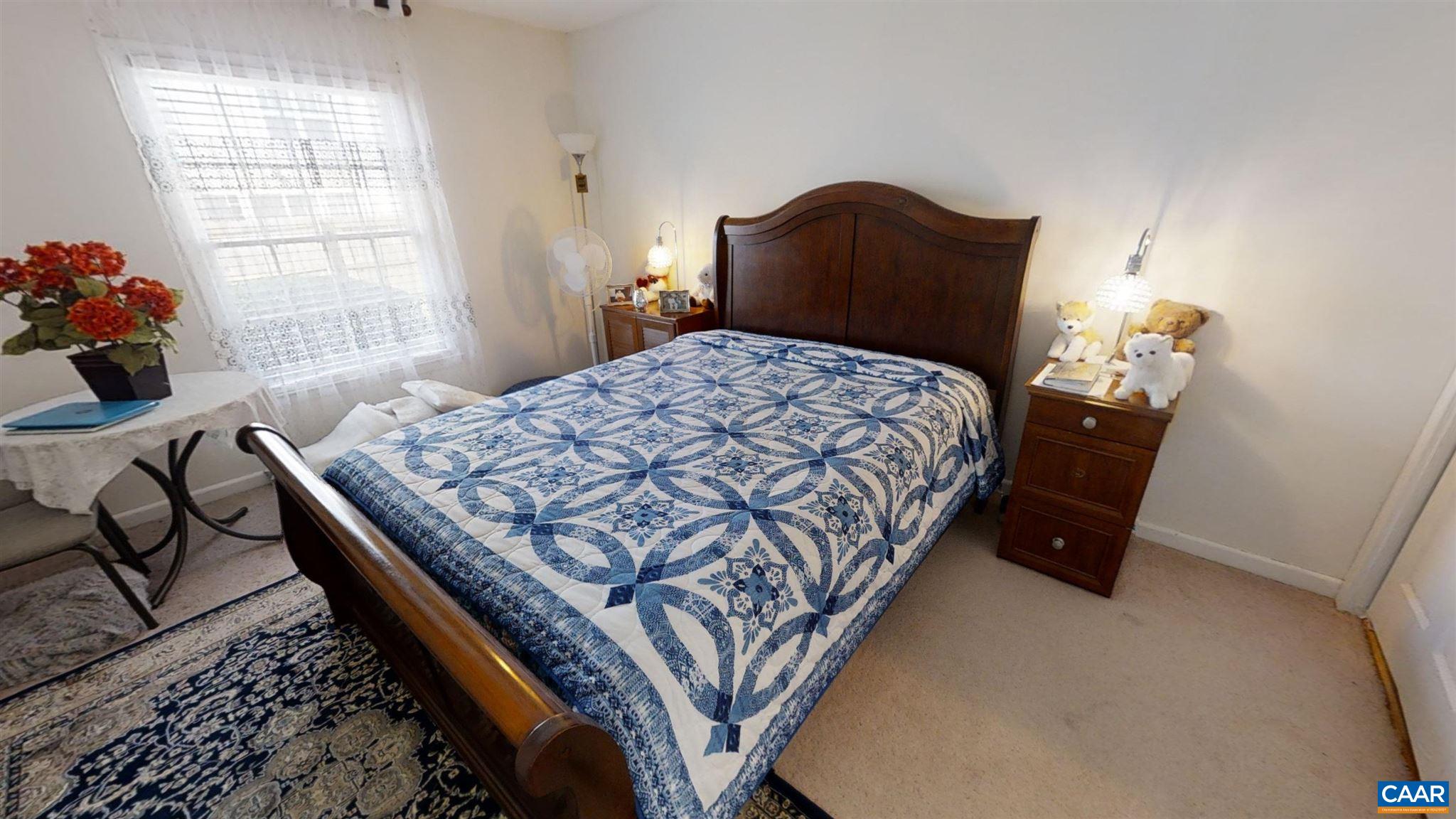 2527 Hydraulic Road, Unit 55 Charlottesville, VA 22901 - Photo 7 of 17 a bed sitting in a bedroom next to a window
