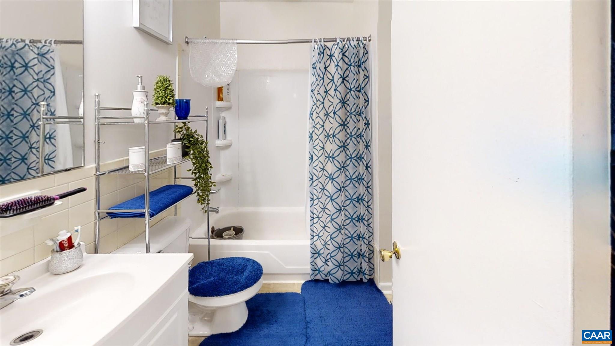 2527 Hydraulic Road, Unit 55 Charlottesville, VA 22901 - Photo 8 of 17 a bathroom with a sink toilet and shower