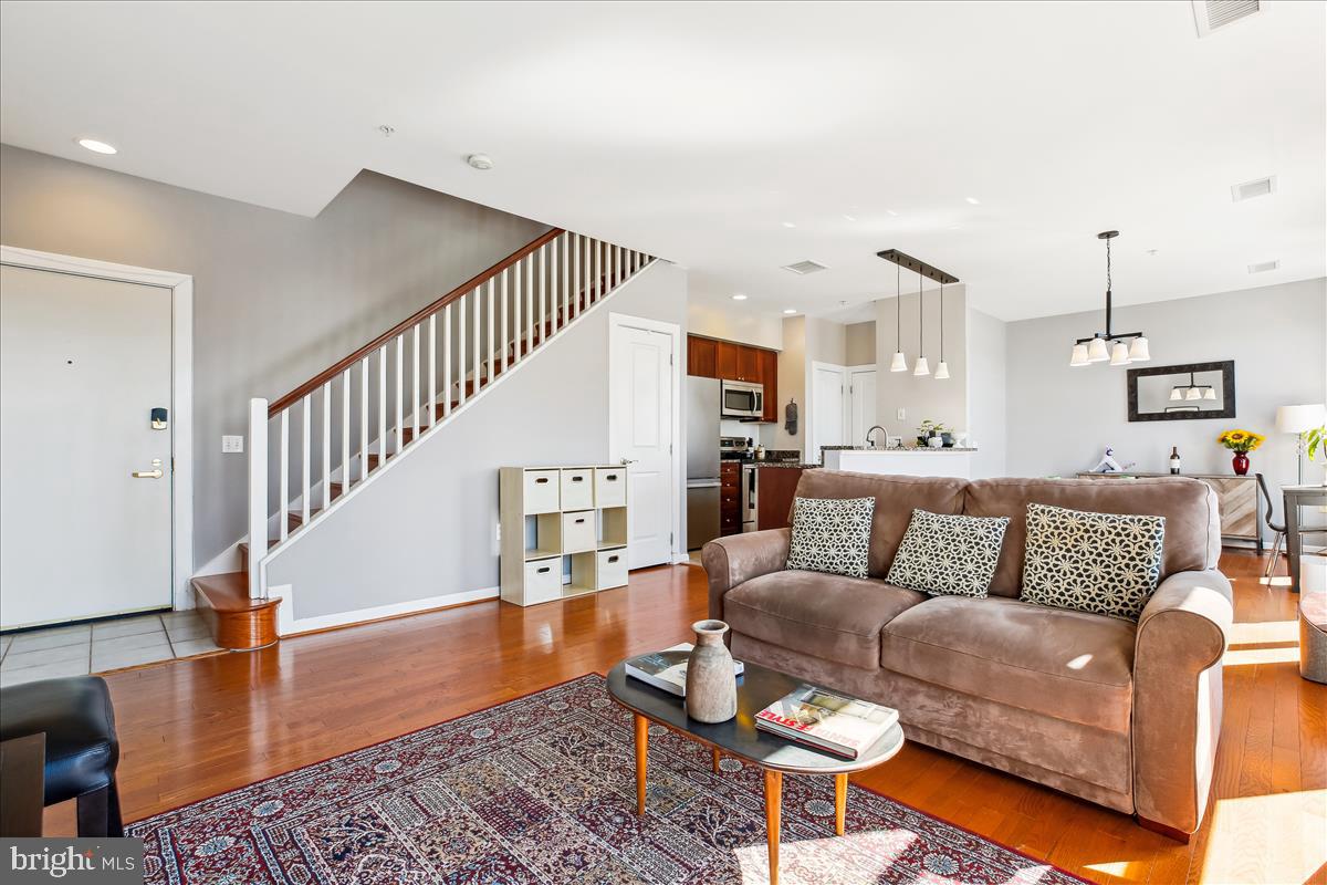 343 Cedar Street Northwest, Unit 323 Washington, DC 20012 - Photo 1 of 71 a living room with furniture and wooden floor