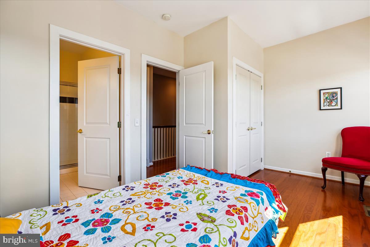 343 Cedar Street Northwest, Unit 323 Washington, DC 20012 - Photo 25 of 71 a bedroom with a bed and a bookshelf