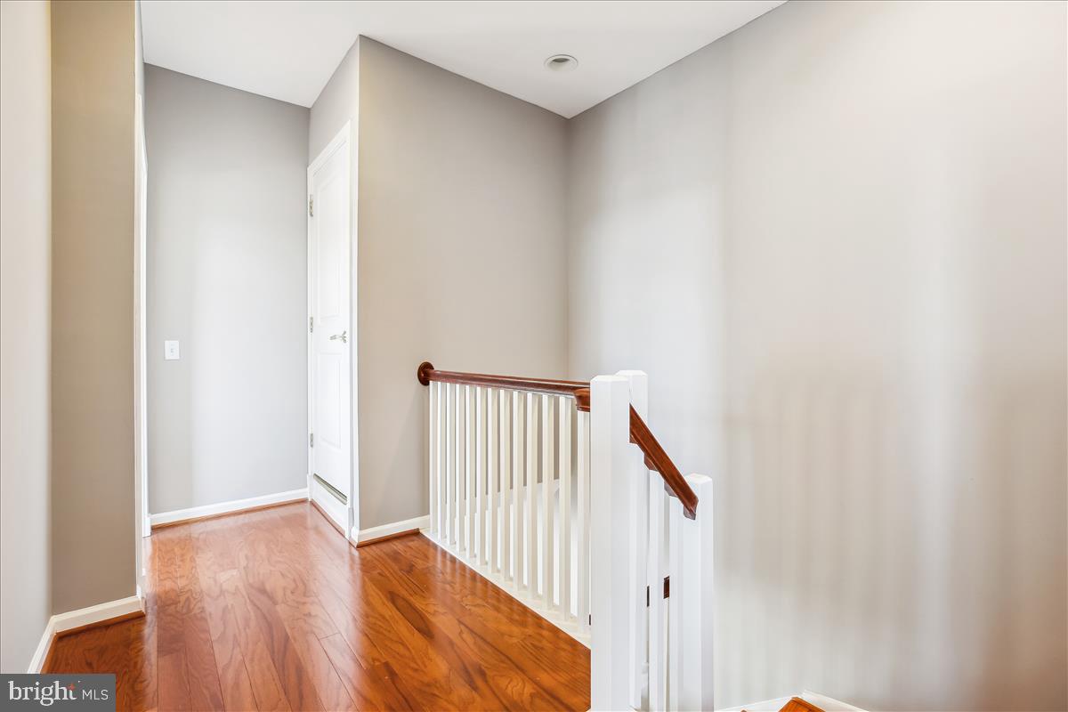 343 Cedar Street Northwest, Unit 323 Washington, DC 20012 - Photo 27 of 71 a view of a hallway with wooden floor and entryway