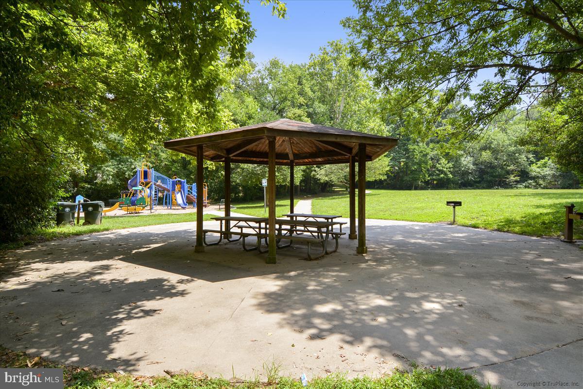 343 Cedar Street Northwest, Unit 323 Washington, DC 20012 - Photo 60 of 71 a view of a park with table and chairs under an umbrella