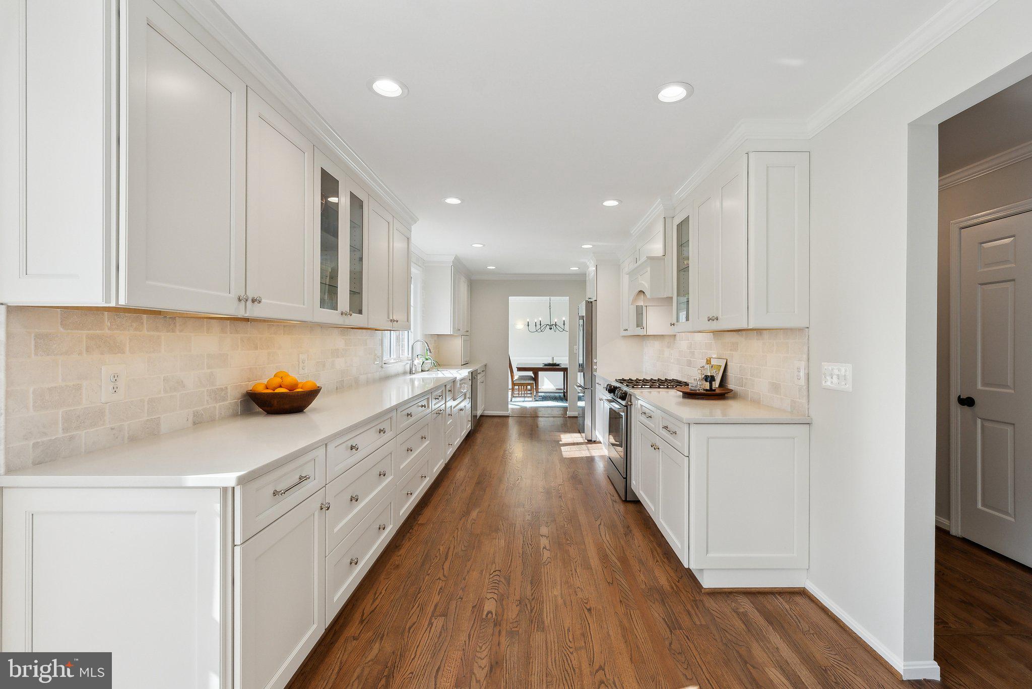 2623 Steeplechase Drive Reston, VA 20191 - Photo 11 of 69 a large kitchen with stainless steel appliances granite countertop a lot of counter space and wooden floors