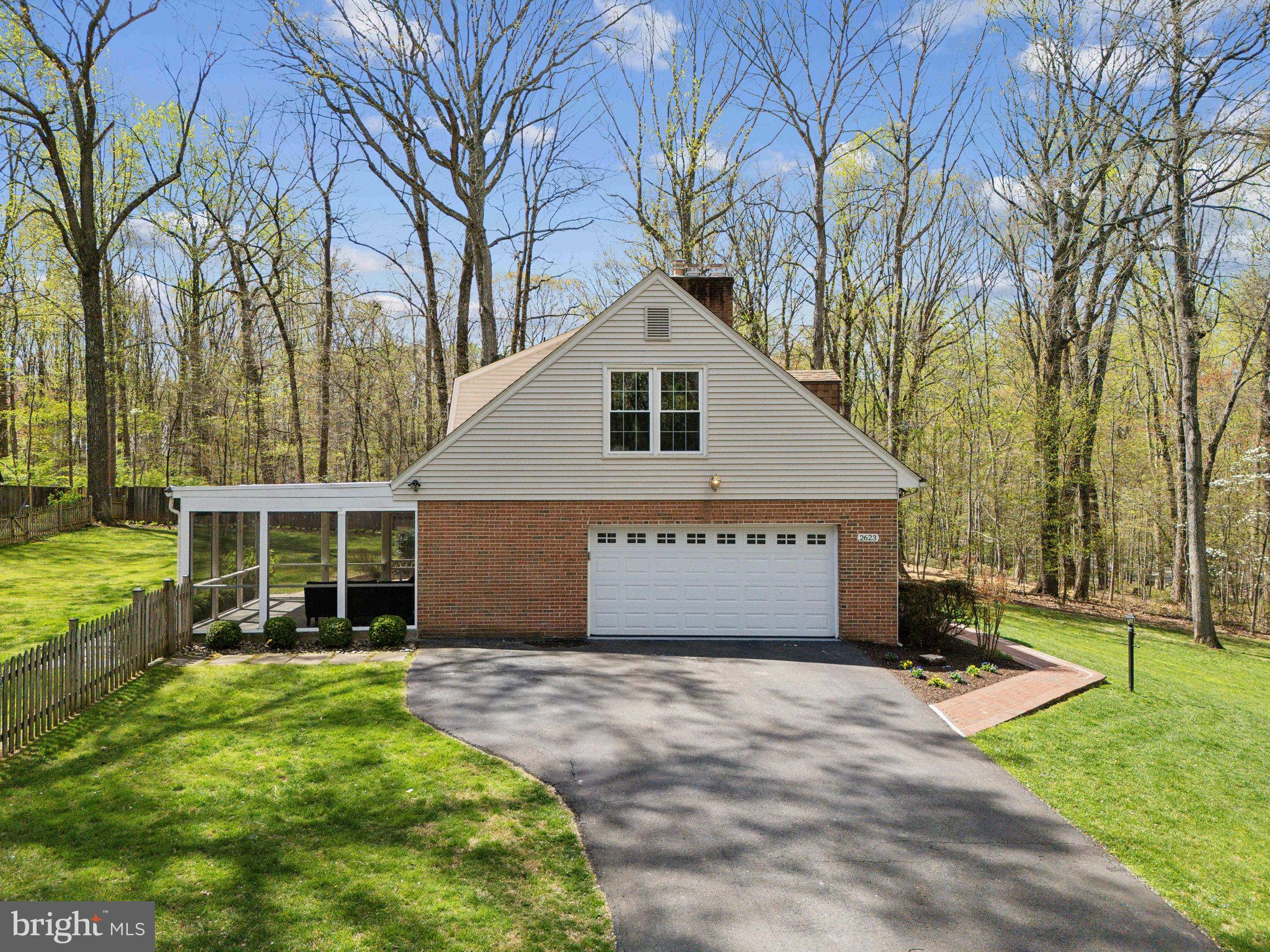 2623 Steeplechase Drive Reston, VA 20191 - Photo 2 of 69 a front view of a house with a garden and trees