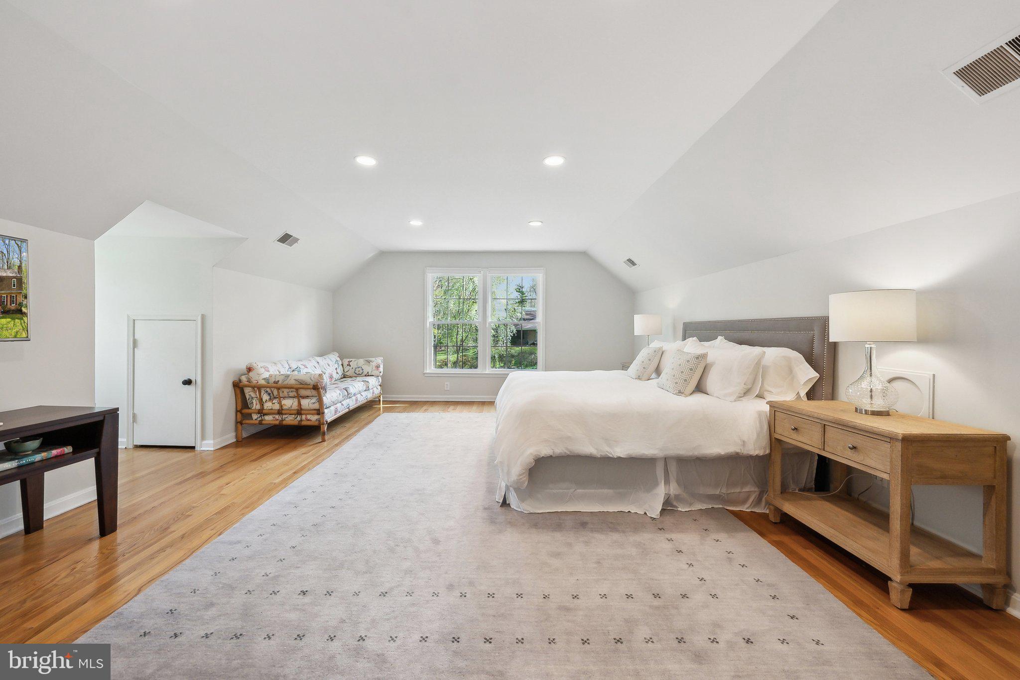 2623 Steeplechase Drive Reston, VA 20191 - Photo 27 of 69 a spacious bedroom with a bed a table and a large window