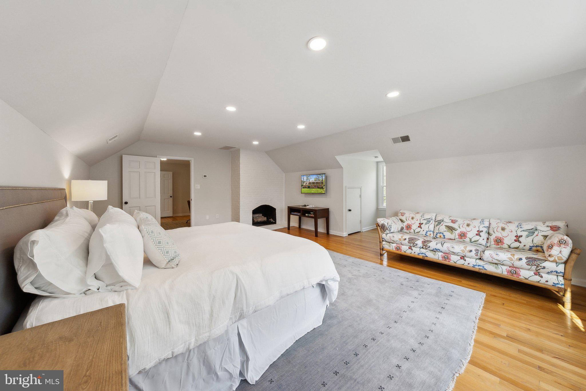 2623 Steeplechase Drive Reston, VA 20191 - Photo 30 of 69 a spacious bedroom with a bed and a couch