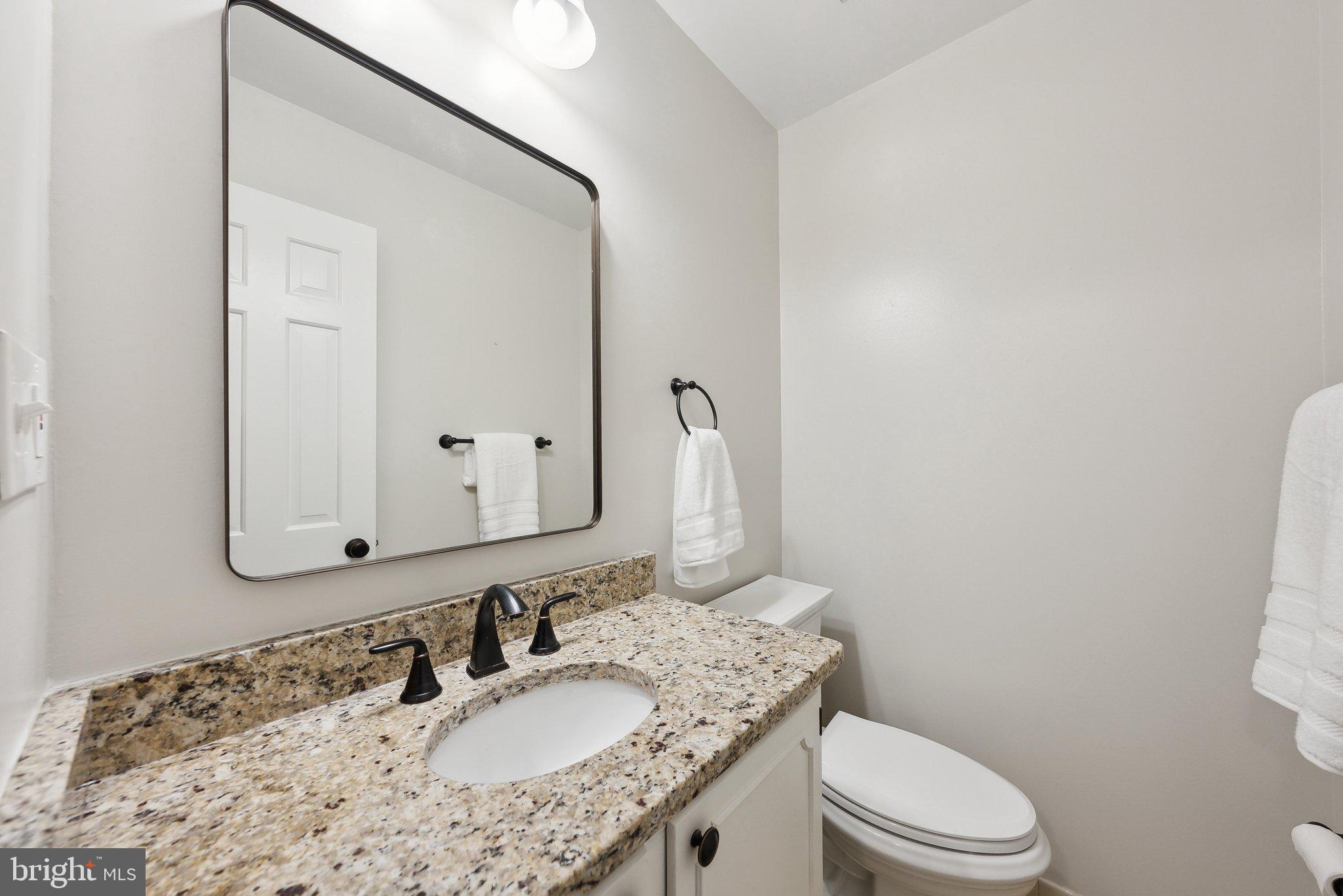 2623 Steeplechase Drive Reston, VA 20191 - Photo 34 of 69 a bathroom with a granite countertop sink a toilet and mirror