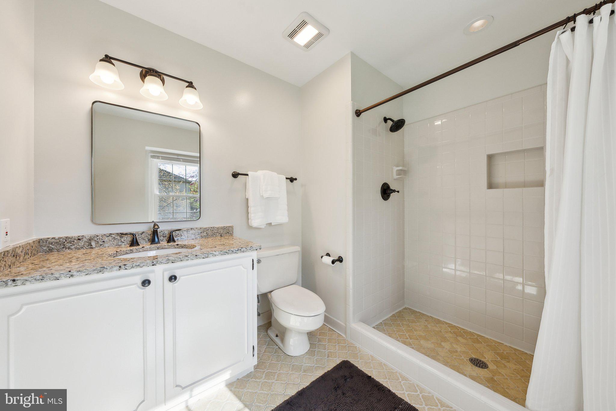 2623 Steeplechase Drive Reston, VA 20191 - Photo 36 of 69 a bathroom with a granite countertop sink mirror shower and toilet