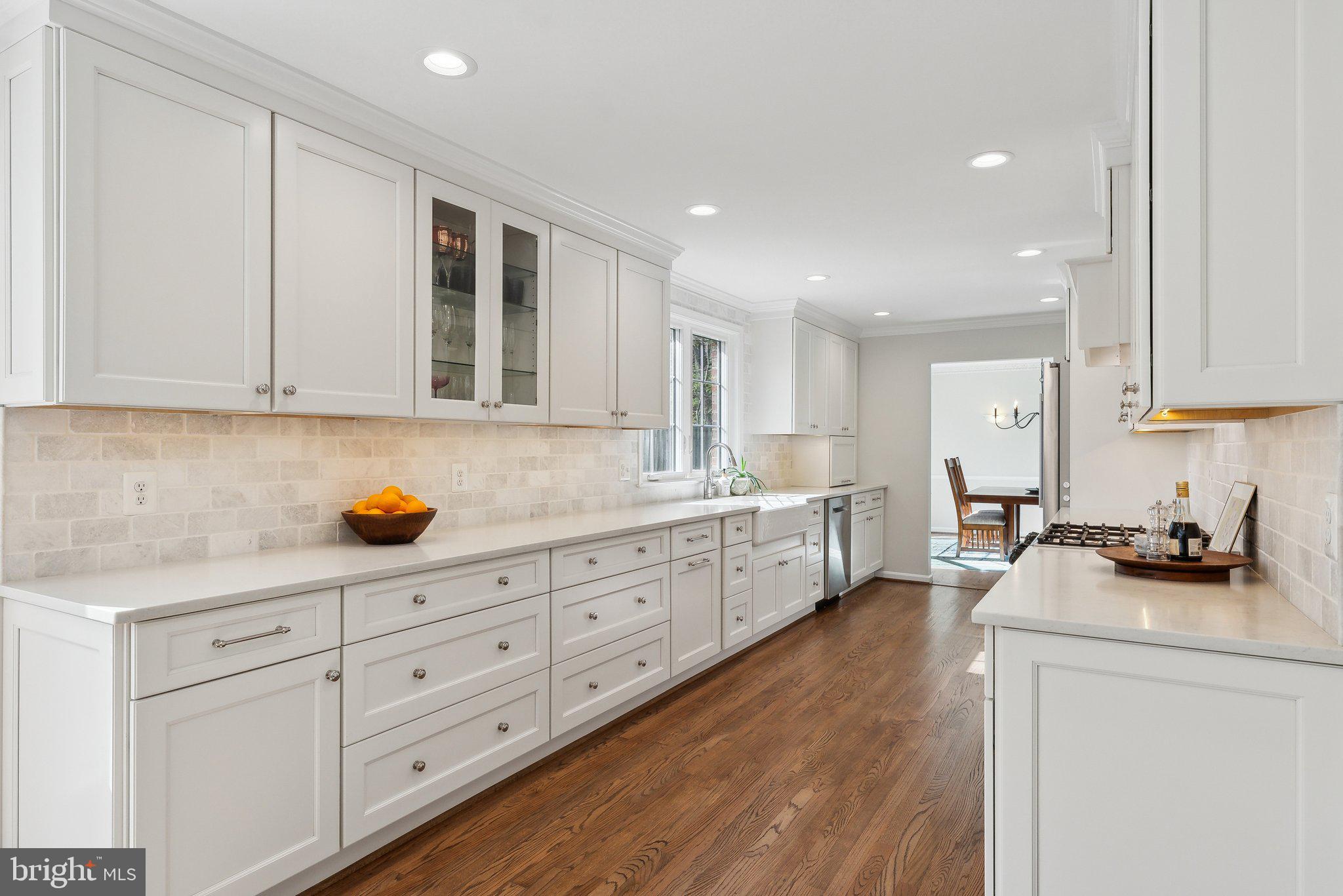 2623 Steeplechase Drive Reston, VA 20191 - Photo 10 of 69 a kitchen with granite countertop white cabinets white stainless steel appliances and sink