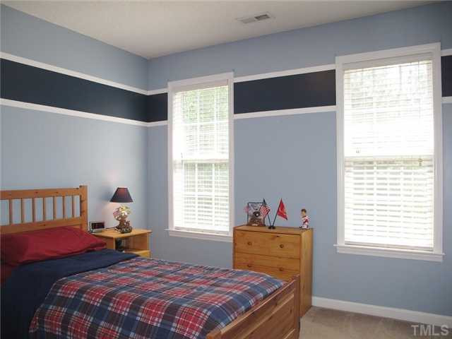 427 Saddle Ridge Drive Willow Spring, NC 27592 - Photo 13 of 19 a bedroom with a bed and window
