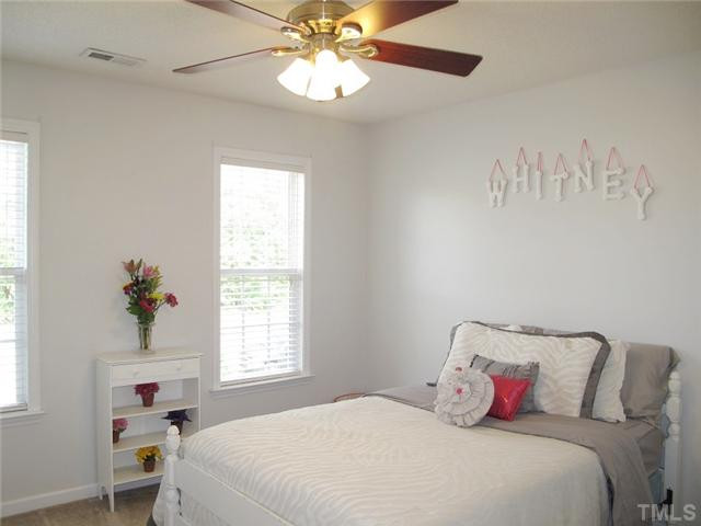 427 Saddle Ridge Drive Willow Spring, NC 27592 - Photo 14 of 19 a bedroom with a bed and a chandelier