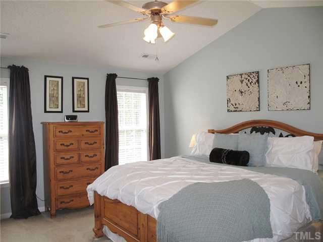 427 Saddle Ridge Drive Willow Spring, NC 27592 - Photo 10 of 19 a bedroom with a bed and a chandelier