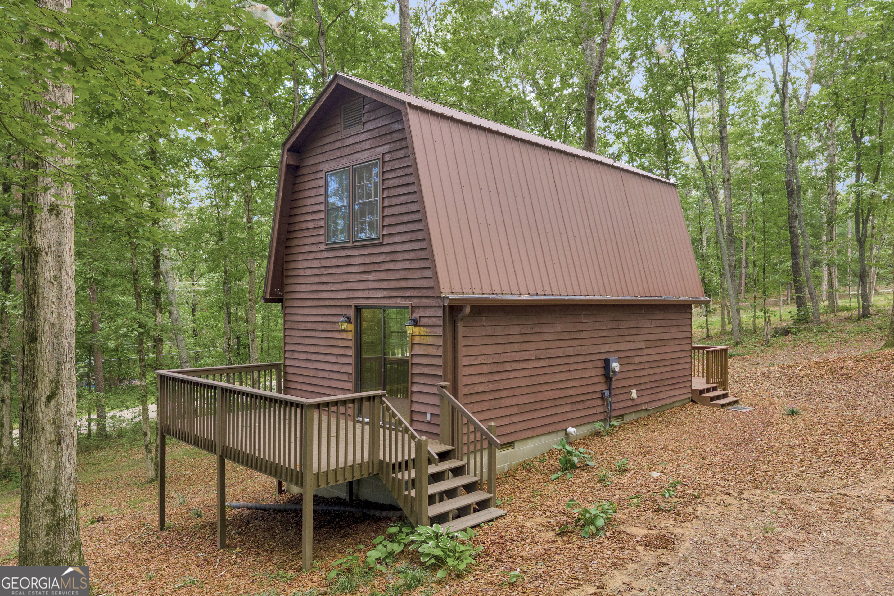 a backyard of a house with table and chairs