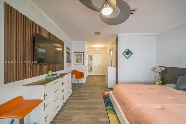 a bed room with a bed mirror and a chandelier