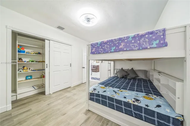 a bedroom with a large bed and a dresser