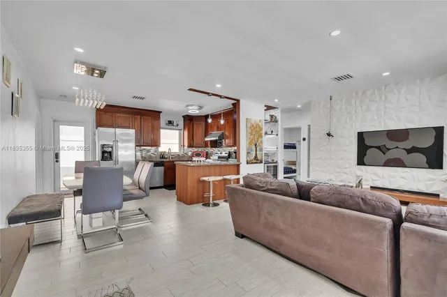 a living room with furniture and kitchen view