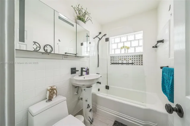a bathroom with a sink a toilet and a bathtub