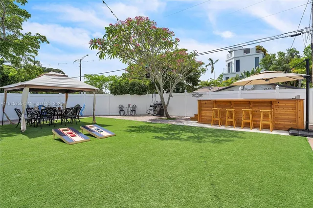 a view of a house with a yard and sitting area