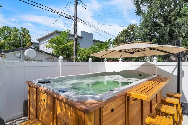 a view of a backyard with plants and a table and chairs