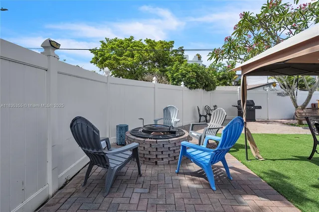 a view of backyard with outdoor seating and green space