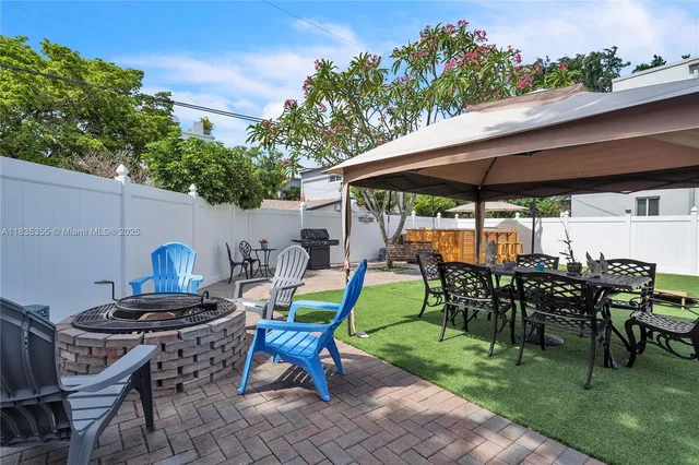 a view of a backyard with sitting area furniture and garden