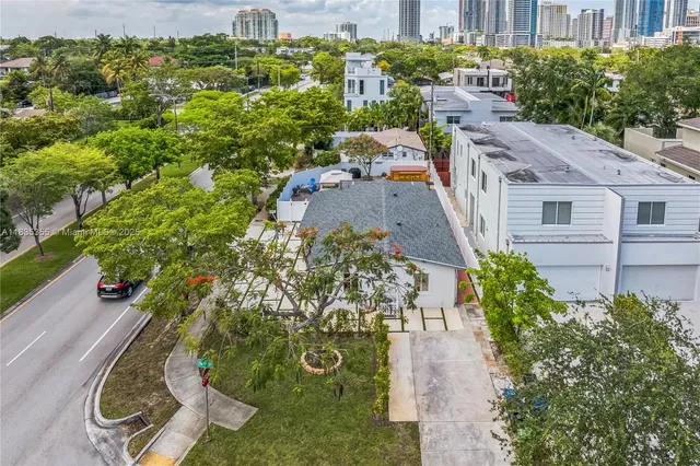 an aerial view of a house with a yard basket ball court and outdoor seating