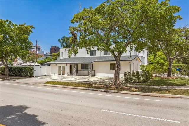 a front view of a house with a garden