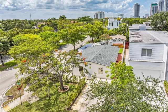 a aerial view of residential houses with yard
