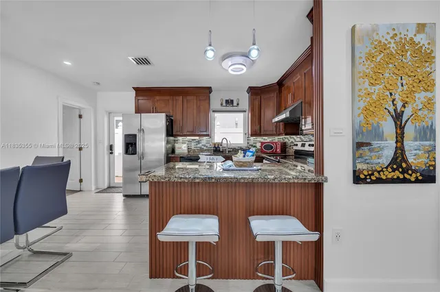 a kitchen with stainless steel appliances granite countertop counter top space cabinets and furniture