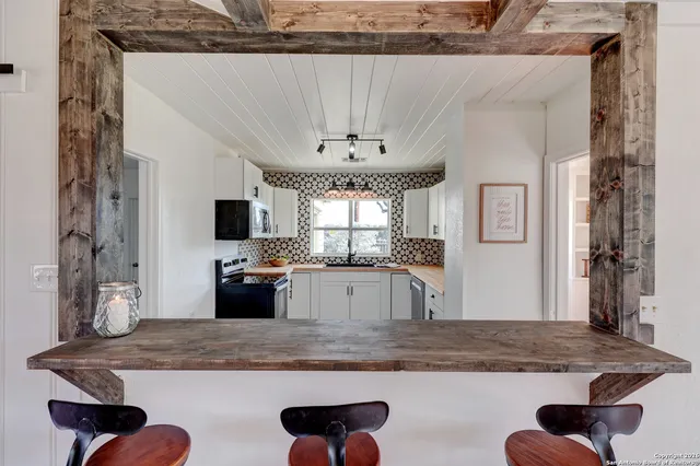 a view of a kitchen with granite countertop a counter top space and stainless steel appliances