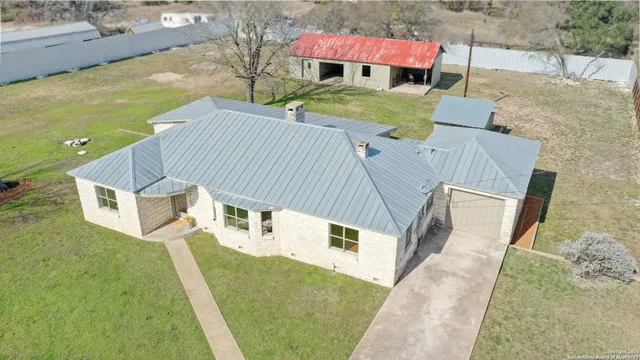 an aerial view of a house with outdoor space
