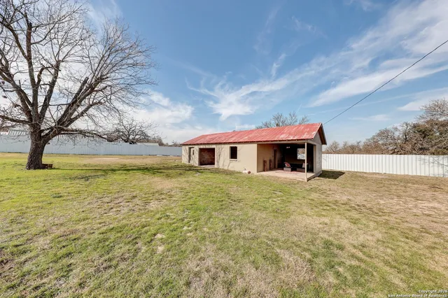 a house view with swimming pool in front of it