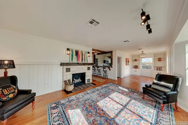 a living room with furniture and a fireplace