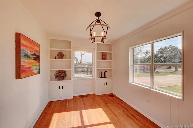 a view of a room with wooden floor and windows