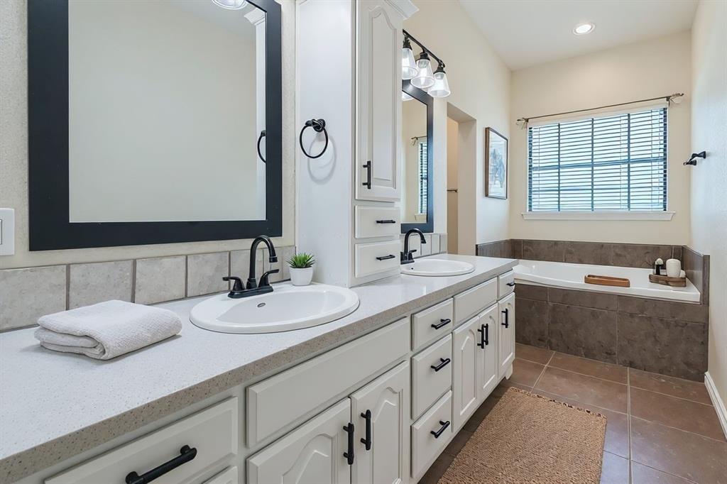 6025 Ge Horton Road Justin, TX 76247 - Photo 12 of 40 Bathroom featuring double vanity, dark tile patterned flooring, a garden tub, and recessed lighting
