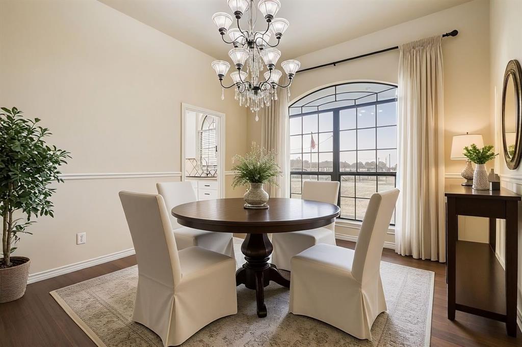 6025 Ge Horton Road Justin, TX 76247 - Photo 5 of 40 Dining space featuring wood finished floors and a chandelier