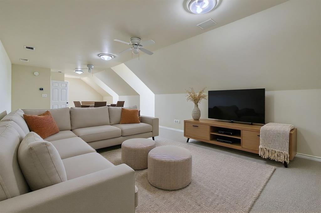 6025 Ge Horton Road Justin, TX 76247 - Photo 9 of 40 Carpeted living room featuring lofted ceiling and ceiling fan