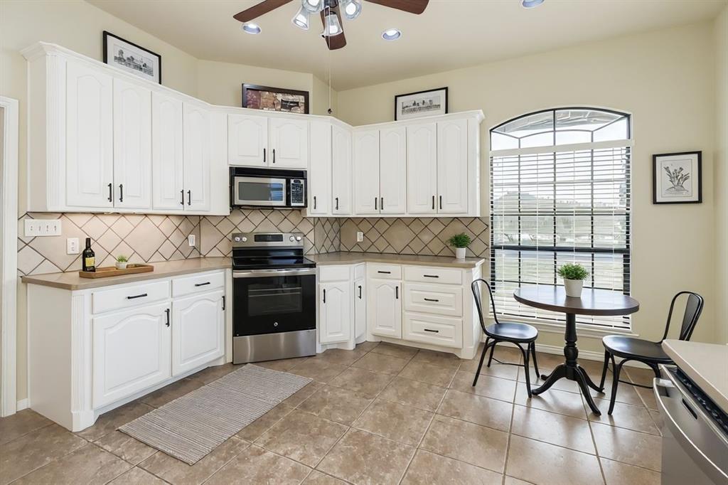 6025 Ge Horton Road Justin, TX 76247 - Photo 10 of 40 Kitchen featuring appliances with stainless steel finishes, tasteful backsplash, white cabinetry, light countertops, and recessed lighting