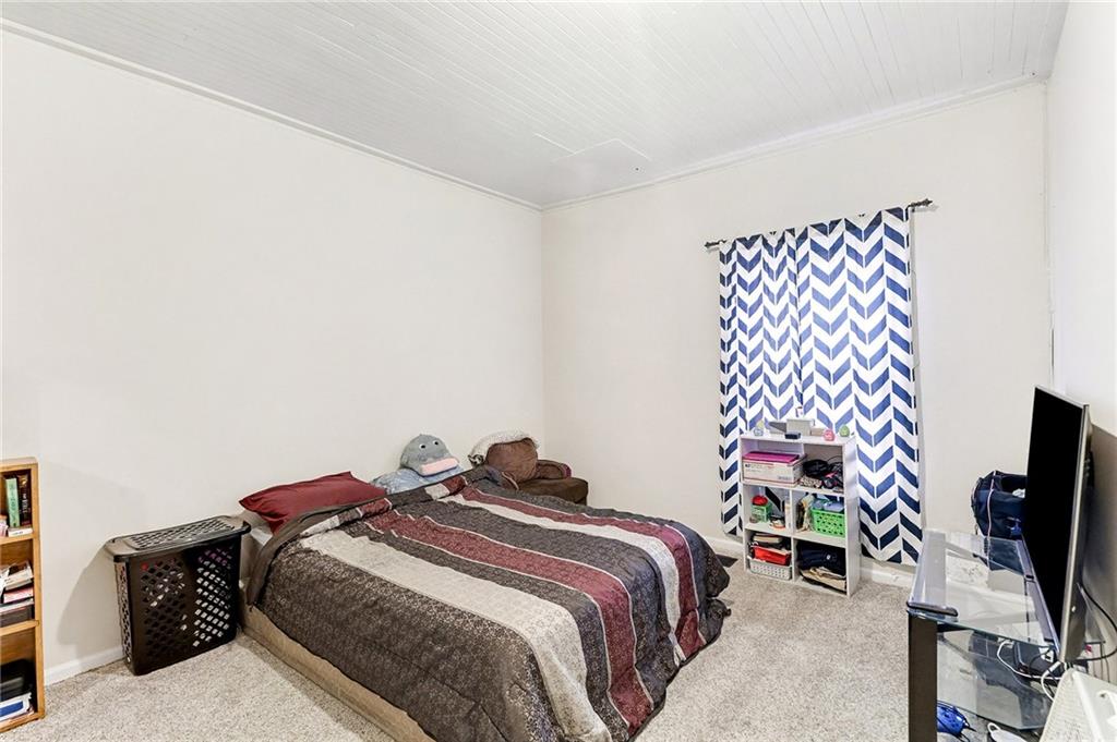 48 Maple Street Grantville, GA 30220 - Photo 13 of 26 a bedroom with a bed and a flat tv screen on a dresser