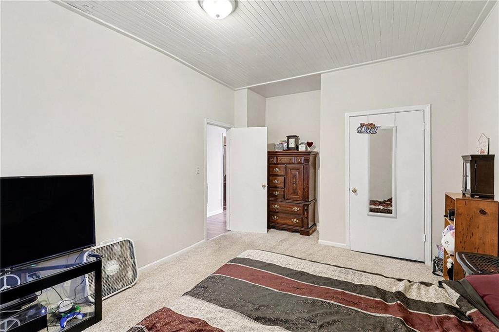 48 Maple Street Grantville, GA 30220 - Photo 14 of 26 a bedroom with furniture and a flat screen tv