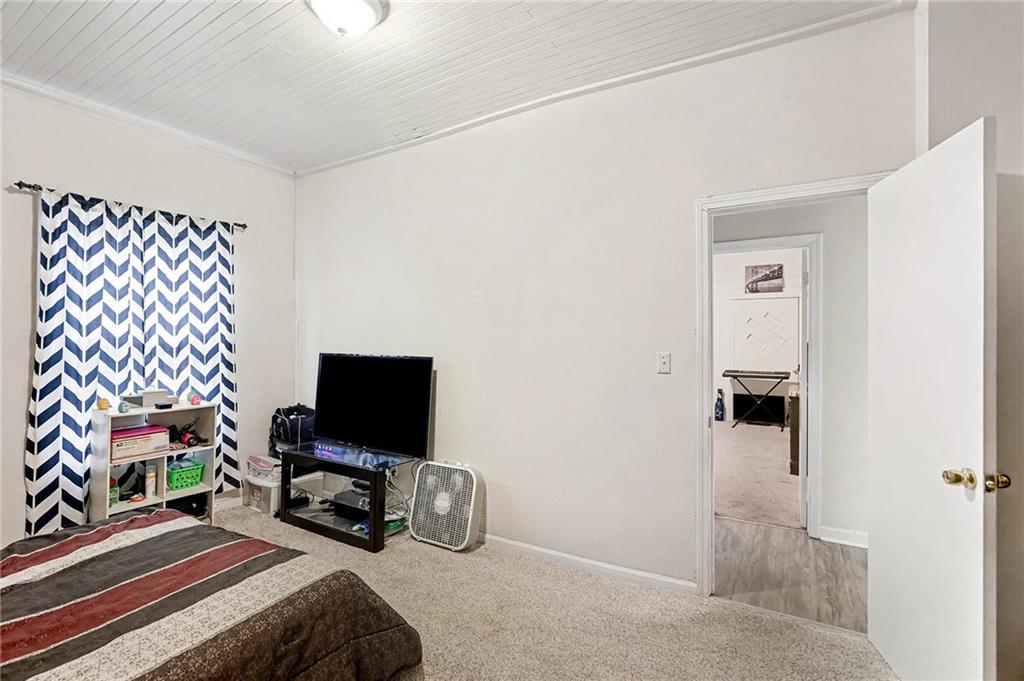 48 Maple Street Grantville, GA 30220 - Photo 15 of 26 a bedroom with a bed and a television