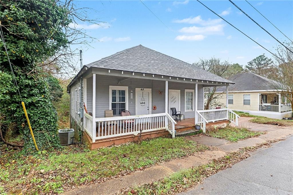 48 Maple Street Grantville, GA 30220 - Photo 2 of 26 a front view of a house with a garden
